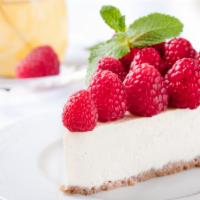 Pomegranate Parfait Cheesecake · Classic Cheesecake with Raspberry Reduction and Whipped Cream.