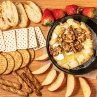 Honey-Nut Brie · A baked brie wheel with a honey-nut glaze. Served with crackers and bread.