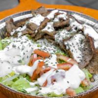 Lamb Over Rice · Rice served with sliced lamb gyro, plus white sauce, lettuce, tomato