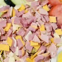 Chef Salad · Crisp lettuce, topped with slices of ham, turkey, Swiss and American cheese, hard boiled egg...