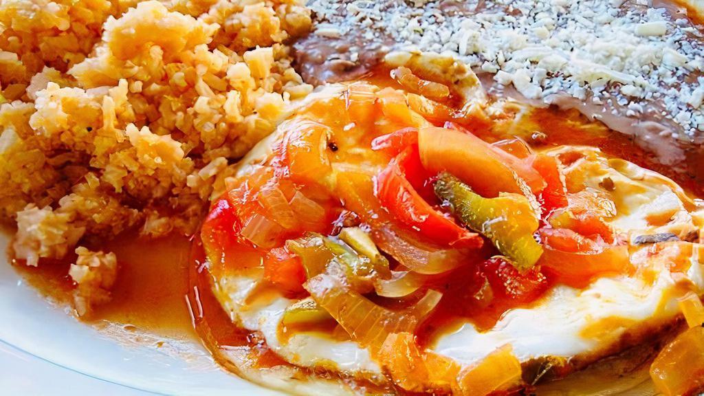 Ranchero Eggs · Served with a side of Mexican rice and beans and corn tortillas.