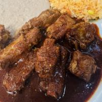 Plate #3 Pork Ribs · Pork ribs slowly cooked in its own juices with green tomatillo sauce, red sauce, green sauce...