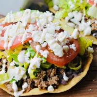 Tostadas · Crispy corn tortilla topped with your choice of meat, refried beans, lettuce, onions, sour c...