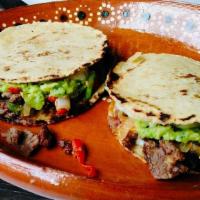 Mulitas · Two thick homemade com tortillas stuffed with melted cheese and your choice of meat.