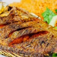 Mojarra Frita · Fried whole tilapia fish served with rice and french fries. Served with rice and refried bea...