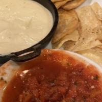 Chips & Dip · Crisp fried tortilla chips served with fire roasted salsa and queso.  Vegetarian