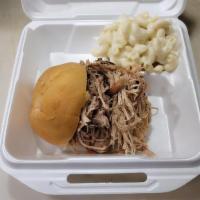 Pulled Pork Sandwich · Smoked pulled pork served on a bun with one side