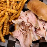 Pulled Turkey Sammich · Enjoy our smoked, all white meat, turkey on a delicious bun.  Served with your choice of one...