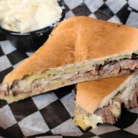 Brisket Garlic Melt · Our smoked brisket with provolone cheese, green chili aioli, and onions lightly pressed on c...