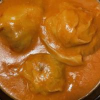 Stuffed Cabbage · Served with ground beef and rice, served in a light tomato sauce and sauté potatoes.