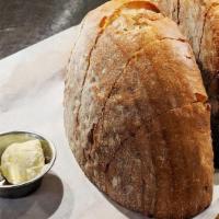 Our Bread, Our Butter · Our scratch-made rustic white boule served with house-churned butter.