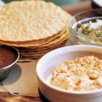 Corn Chips & Dips · Crunchy corn tortillas served with sides of house-made guacamole, salsa, and pimento cheese.