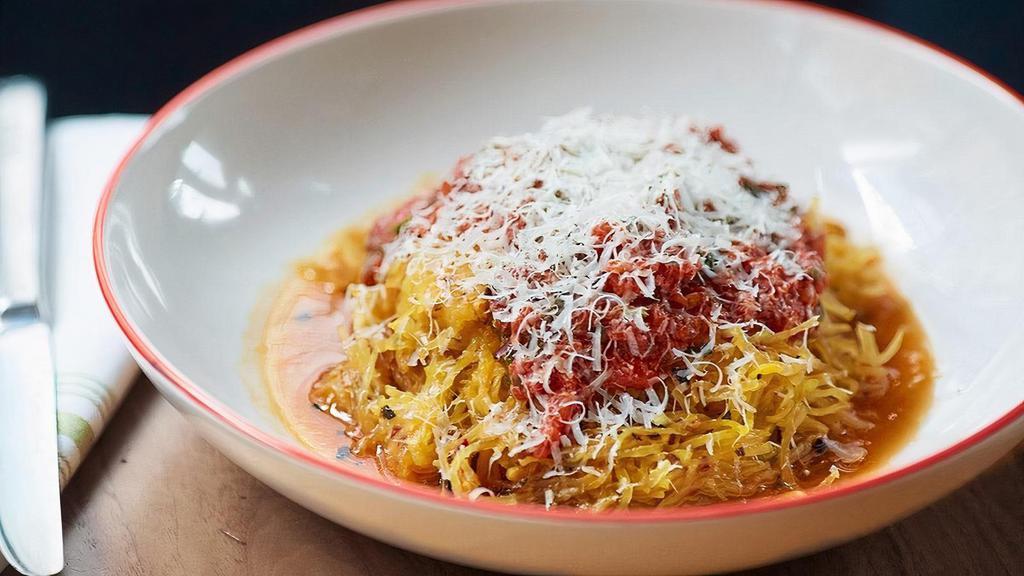 Spaghetti Squash Pomodoro · Roasted spaghetti squash sautéed in olive oil & garlic, served with a light pomodoro marinara sauce, and topped with pecorino cheese.