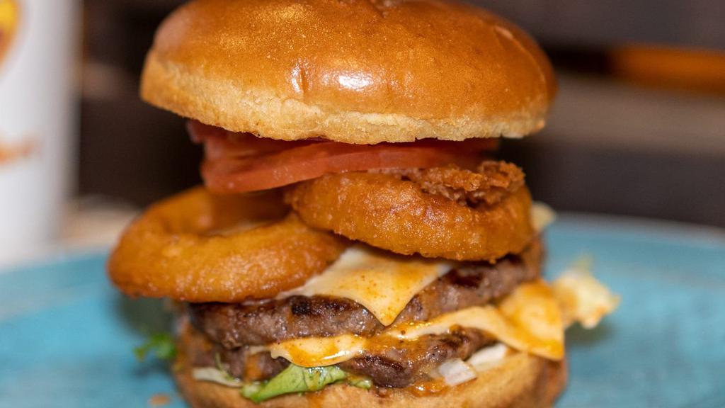 American Burger  · Lettuce, tomato, Onion rings, caramelized onion, gherkin, cheese, mayonnaise, and american Mustard.