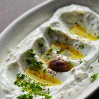 Labneh With Garlic · Strained yogurt mixed with garlic and mint topped with olive oil.