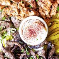 Shawarma Mix · Mix of beef and chicken shawarma with garlic sauce and tahini sauce on the side.