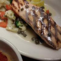 Salmon Steak · Fresh salmon filet chargrilled topped with a lemon butter caper sauce