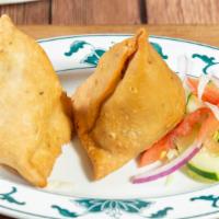 Vegetable Samosa · Traditional triangular patties stuffed with potatoes and peas. Two to an order.