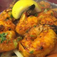 Tandoori Shrimp · Scrumptious jumbo shrimp marinated in an exotic blend of Indian spices, then cooked on skewe...