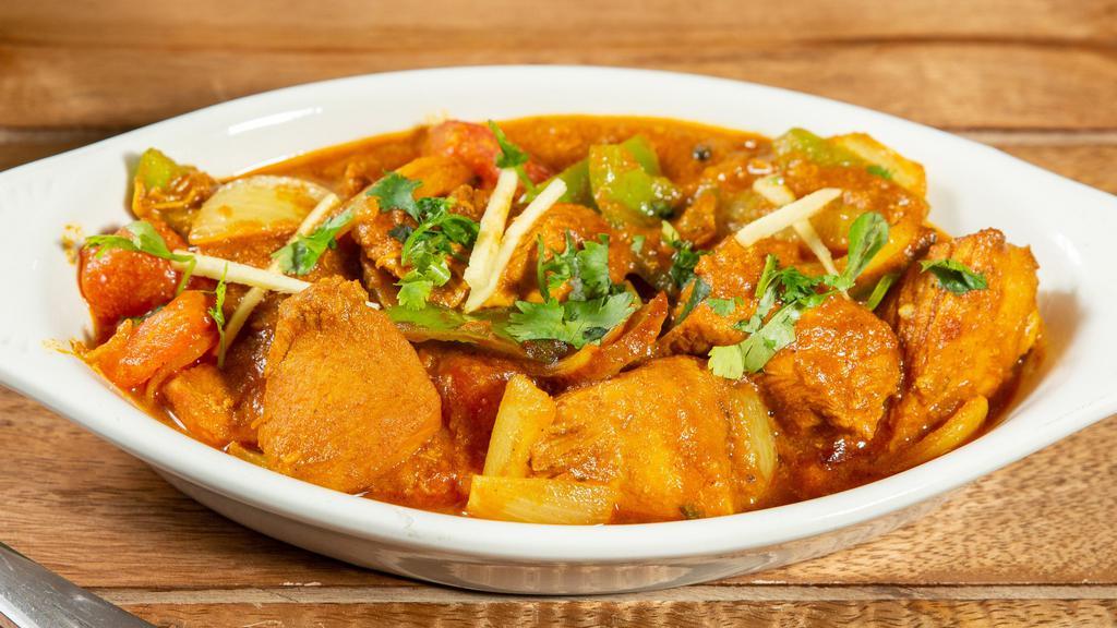Kadai Chicken · Chicken cooked with an exotic blend of curry spices, onion, garlic, ginger and tomato with a medium thick sauce.