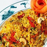 Chicken Biryani · Basmati rice flavored with saffron, cooked with carrots, peas, cauliflower and tomatoes.