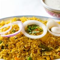 Vegetable Biryani · Basmati rice flavored with saffron, cooked with carrots, peas, cauliflower and tomatoes.