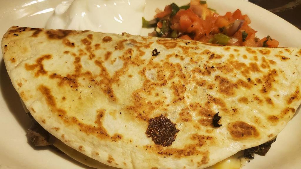 Spinach Quesadilla · Stuffed with melted cheese, spinach, and mushrooms. Served with pico de gallo and sour cream.