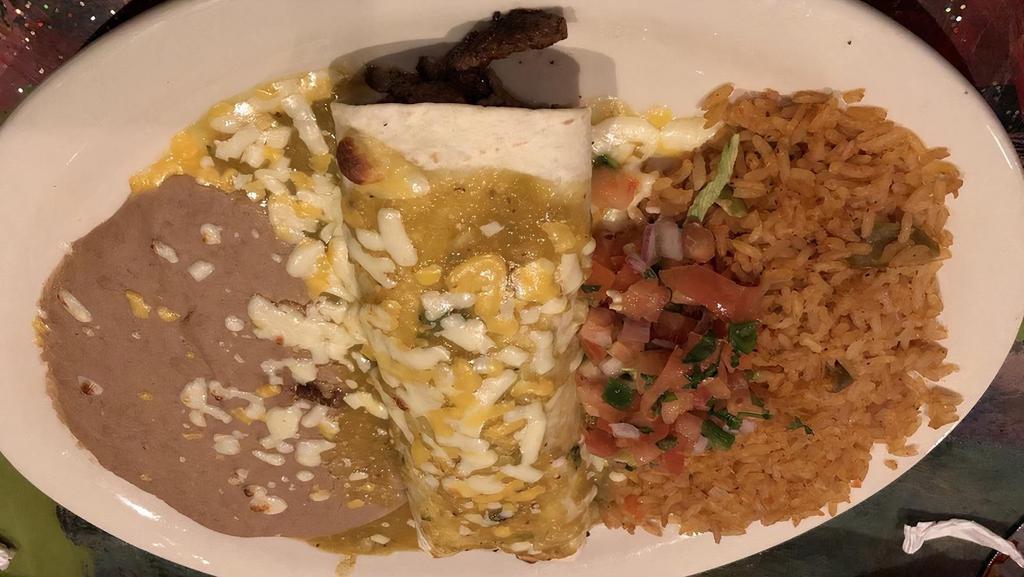 Burrito De Carne Asada · Filled with sirloin steak or chicken then smothered with cheese, tomatillo sauce, and pico de gallo. Served with rice and beans.