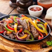 Steak Fajita · Grilled Marinated Steak strips sautéed with onions and peppers accompanied with two sides of...