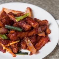 Crispy Chilly Baby Corn · Fried crispy baby corn tossed with onions and chilies in a tangy sauce.