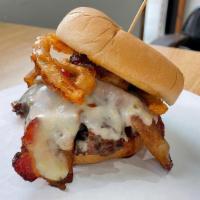 The Rickie Fowler · A 1/3 all-beef patty topped with bacon strips, Shoup's BBQ sauce, Pepper Jack cheese, a cris...