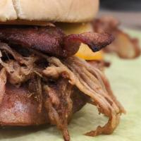 The Triple Tiger · Shaved ham, smoked pulled pork and crispy bacon, topped with Cheddar cheese and smothered in...