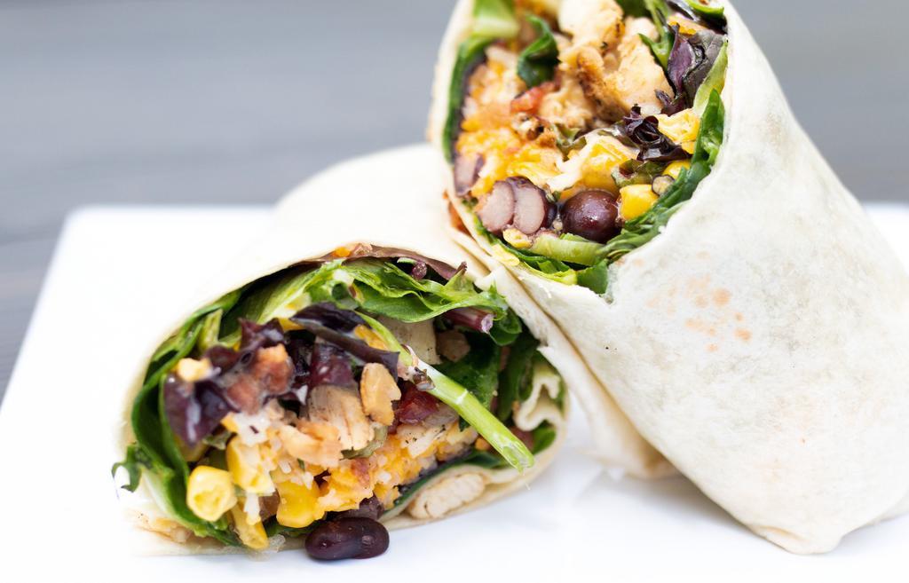 Southwest Chicken Wrap · Chicken with shredded cheese, chopped bacon, fresh greens, homemade corn salsa and cilantro ranch wrapped in a hot-pressed tortilla.