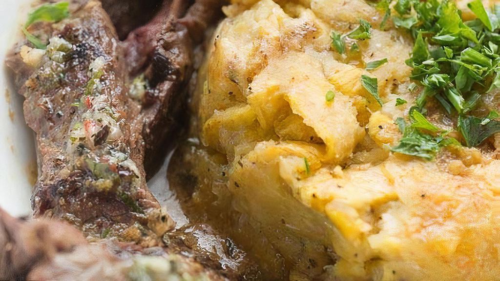Steak Mofongo · Mashed Plantains Infused with Garlic Topped with Steak.