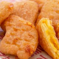 Mac 'N Cheese Bites · Crispy, golden brown, fried spoonfuls of mac n cheese coated in breadcrumbs.