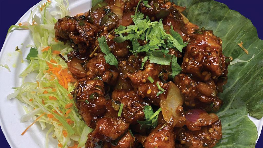 Chili Chicken · Crispy Chicken Tossed with Onions, Bell Peppers & Chef's Special Sauce.