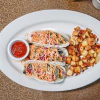 Breakfast Tacos · Scrambled eggs with black beans, cheese, red cabbage and chipotle mayo served on a warm tort...