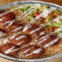 Falafel Over Rice · Served with lettuce, tomatoes, white sauce and hot sauce.