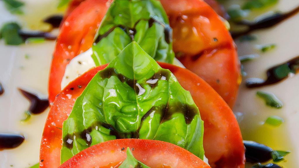 Caprese Salad · Fresh water Mozzarella, vine ripe tomatoes and basil leaves, served with EVOO and balsamic glaze.
