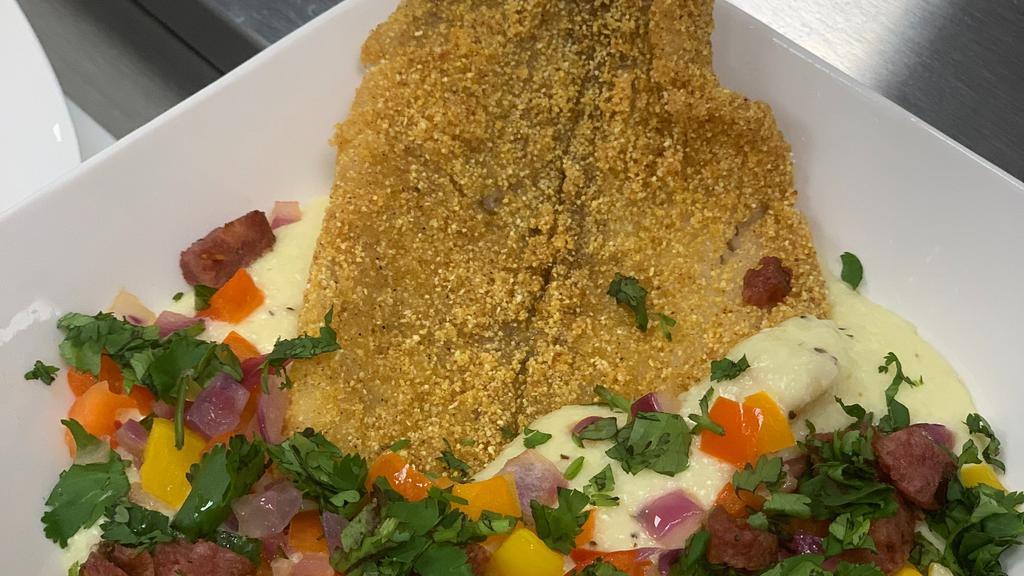 Catfish & Grits · Fried catfish filet over a creamy bed of grits.