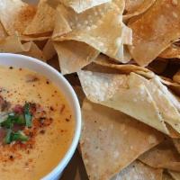 Chips & Queso · 6 oz. queso cheese and tortilla chips.