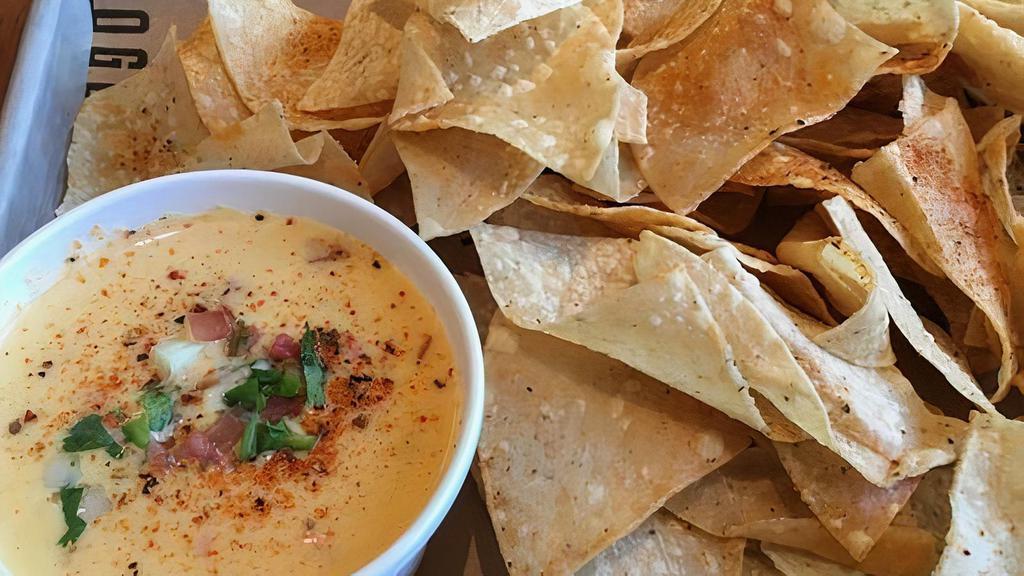 Chips & Queso · 6 oz. queso cheese and tortilla chips.