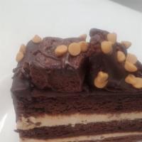 Peanut Butter Explosion · Rich dense chocolate cake with peanut butter layered in between. Topped with Fudge brownie a...