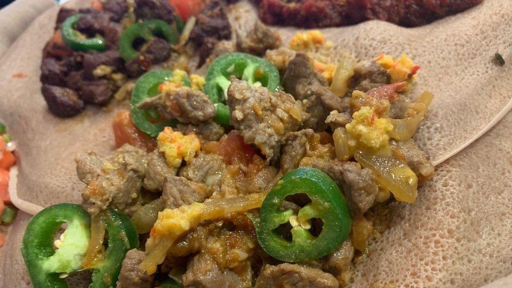 Yebeg Alecha · Lamb chunks sautéed with onion, green pepper and flavored with black pepper and Ethiopian butter.
