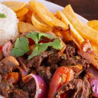Lomo Saltado · Steak strips sautéed in olive oil, red onions, peppers, tomatoes, French fries and fresh her...