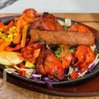 Royal Kebab Platter · A combination of clay oven delicacy Tandoori chicken – Chicken tikka – Lamb seekh kebab – Ta...