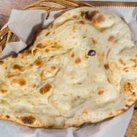 Naan · Traditional unleavened white bread.