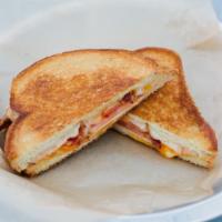 Griddled Cheese · Cheddar, Swiss, Provolone, and smoked Gouda cheeses, tomato, and bacon on Texas toast.