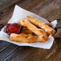 Breadsticks · Order of six golden brown breadsticks made from our fresh homemade pizza dough and served wi...