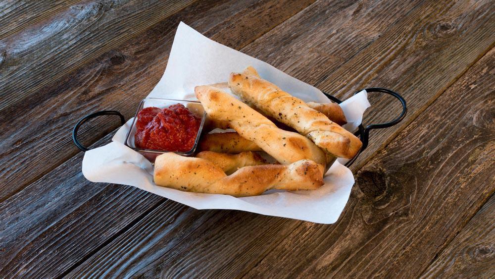 Breadsticks · Order of six golden brown breadsticks made from our fresh homemade pizza dough and served with your choice of dipping sauce.